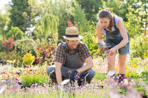 Gardeners Palmers Green working safely with protective equipment