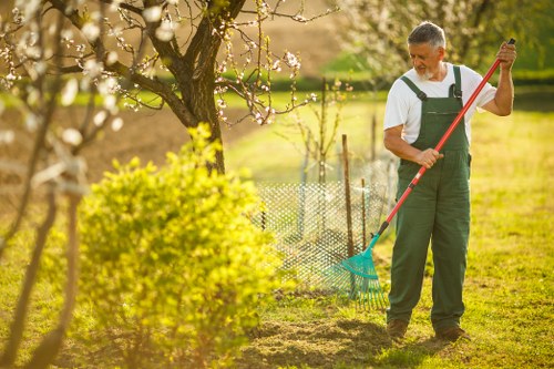 Trained gardening staff performing careful outdoor work